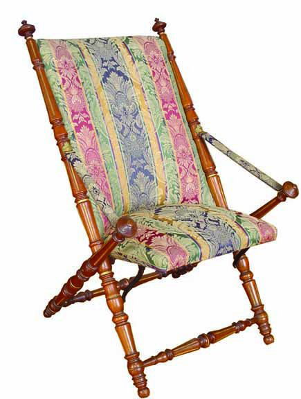 VICTORIAN FOLDING CHAIR W/ BZ WINGED CUPIDS 30132: Elaborate Victorian folding chair with bronze mounted winged cupid heads holding the straping arm rest and gold incised detailing. Dimensions: 39"H x 25"W x 30"D Age: C.1880 Material: Oak