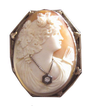 LG 14K LADY CAMEO PIN WITH DIAMOND 3299: Oversized cameo in pink and white with remarkable details including 14K gold holder and hexagon shaped diamond necklace. Dimensions: 2 1/2"H x 1 7/8"W Age: C. 1900 Material: Gold and Diamond