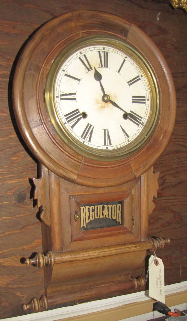 REGULATOR WALL CLOCK #13160 W/ ROLL PIN BOTTOM 1519: Regulator wall clock #13160 with "rolling pin" carved bottom. Dimensions: 22"H x 12"W x 5"D Age: 1900 Material: Walnut