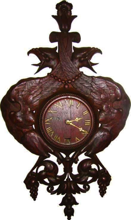 OAK SETH THOMAS WALL CLOCK GRIFFINS / PHEONIX 1673: Marvelous & rare to find quartered oak Seth Thomas wall clock with back to back Phoenix / griffins haveing a decorative bottom with grape accents, and rosette top. Dimensions: 37"H x 21"W x 4"D Age: 1