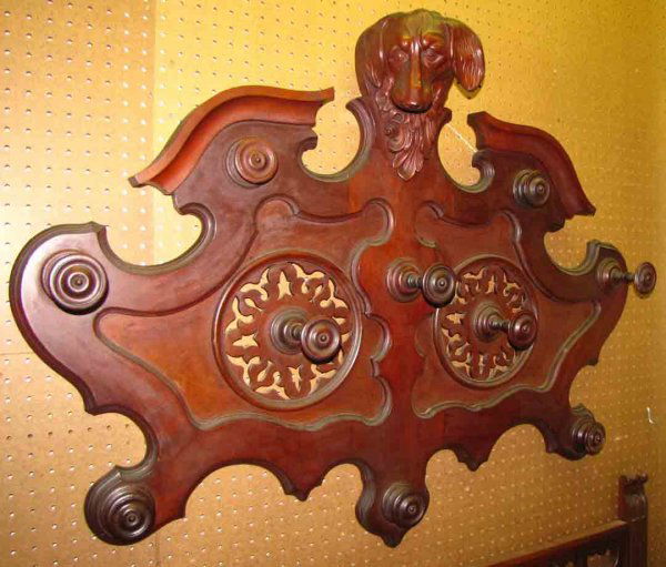 CVD WALNUT VICT.WALL HAT COAT RACK W/DOG HEAD 1672: Carved walnut Victorian wall mounted rack with dog head crest and pinwheel motif center. Dimensions: 34"H x 45"W x 8"D Age: C.1880. Material: Walnut wood
