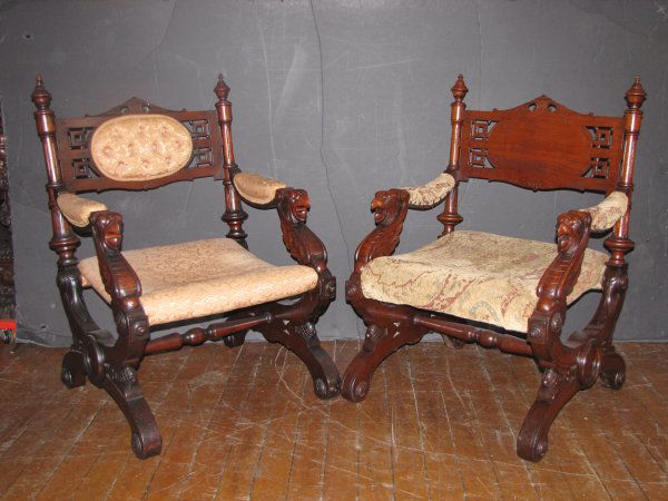 PR RENAISSANCE PHOENIX HEAD WALNUT ARM CHAIRS 1674: Two incredible Renaissance carved walnut chairs with Phoenix bird head arm rests, pine cone accented base, and incised medallions throughout. Dimensions: 37"H x 26"W x 26"D. Age: 1880 Material: Walnut