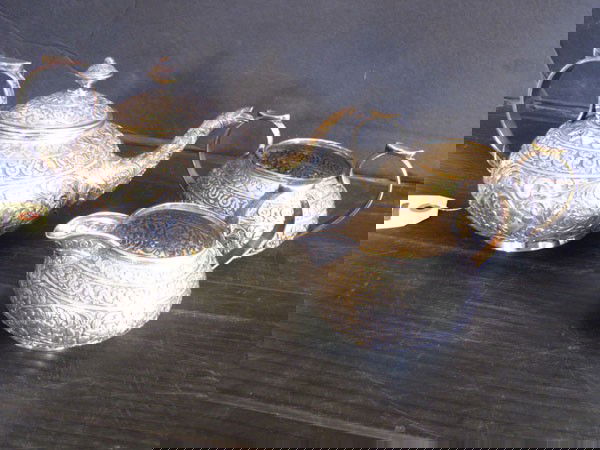 HIGHLY DECORATIVE 3PC PERSIAN SILVER TEA SET(1661): Highly decorative three piece Persian Silver tea set in the highest of quality. 34.26 Troy Ounces. Dimensions: tea pot- 4.5"H x 8.5"L x 5"D Age: 1900 Material: Silver