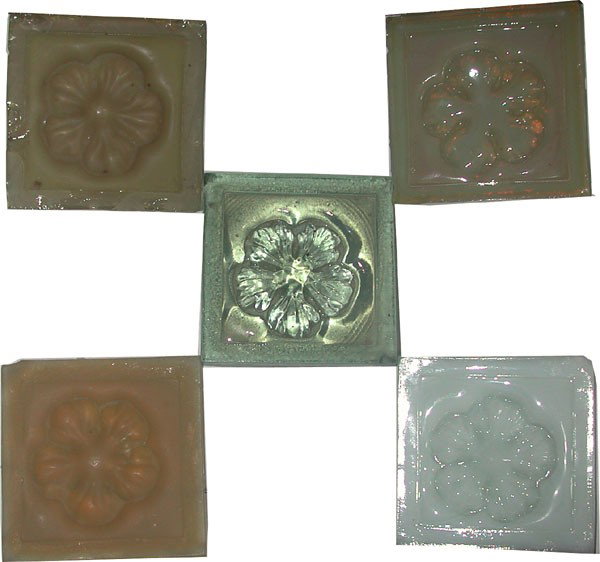 SET OF 5 TIFFANY ART GLASS FLORAL MOTIF TILES (2): Set of five Tiffany art glass floral motif tiles, 1 white 1 greenish-color 3 amber color. Some have minor chips. Dimensions: 3"Sq Age: 1880 Material: Art Glass