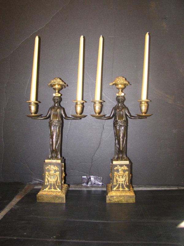 PR GILT BZ EMPIRE STYLE LADY 2ARM CANDLEABRAS 1650: Remarkable pair of gilt bronze Empire style lady two-arm candelabras with decorative flamed torch, urn includes ram heads & garland accented base. Dimensions: 20.5"H Age: 1920 Material: Bronze
