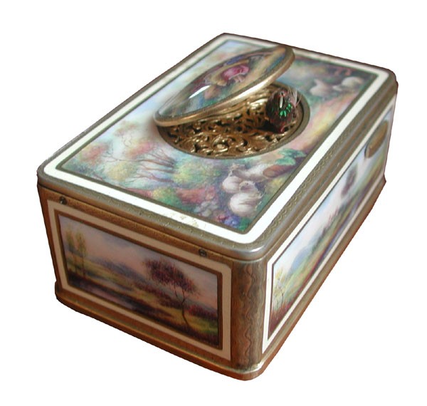 KARL GRIESBAUM TABATIERE W/GOLD PLATED ACCENTS 1679: Karl Griesbaum Tabatiere in hand painted enamel with gold plated accents of lounging couple with sheep top scene with landscape side scenes. Dimensions: 1.5"H x 4"L x 2.5"D Age: 1920 Material: Enamel 