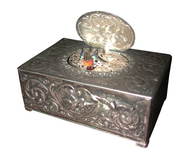 HVY EMBOSSED KARL GRIESHAUM TABATIERE MRKD800(1680): Karl Grieshaum Tabatiere marked 800 silver, heavily embossed with birds & dancing Putti in a floral & foliate design, includes maker mark. Dimensions: 1.5"H x 4"L x 2.5"D Age: 1920 Material: 800 Silve