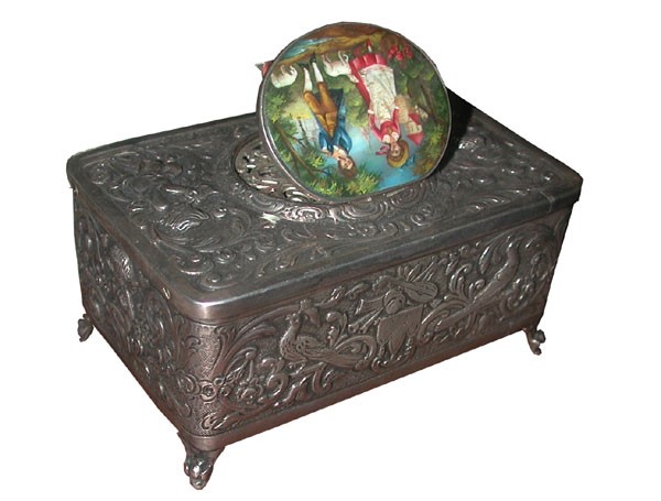HEAVILY EMBOSSED STERLING TABATIERE W/CUPIDS 1681: Marked Sterling Tabatiere heavily embossed with winged cupids, has maker mark V.S.H. w/ swan. The lid is enamelled with girl & boy in garden w/ lambs. Dimensions: 1.75"H x 4"L x 2.5"D Age: 1900 Materi