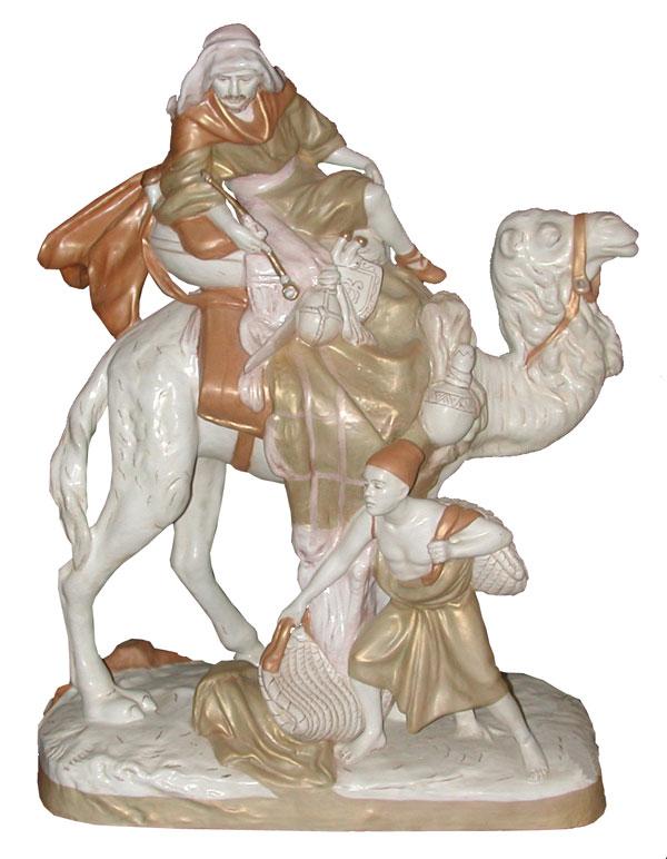 ROYAL DUX LG CAMEL W/ RIDER & BOY W/ BAGS 4113: Phenomenal marked Royal Dux over-sized Camel with rider holding pipe and boy with bags. Dimensions: 23.5"H x 18"W x 9"D Age: 1890 Material: Porcelain
