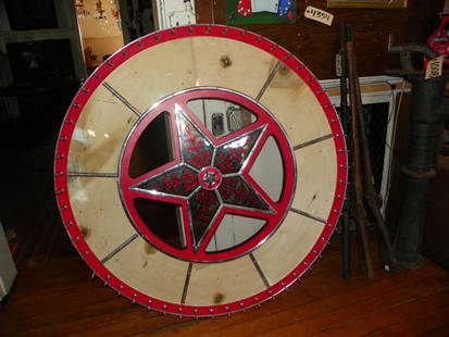 ORIGINAL GAMBLING WHEEL WITH MIRRORED STAR CTR 4424: Original gambling wheel with mirrored star center. Blank for personal choice of theme: numbers, cards, pictures etc. Dimensions: 48"Dia Age: Circa 1920 Material: Metal, wood & mirror