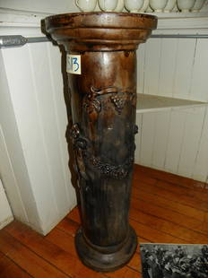 PLASTER PEDESTAL FLORAL & GRAPE MOTIF 1513: Plaster pedestal with ribbon, floral garland and grapes with vines, note a small hole in lower area. 36"H x 12"Dia. Age: C.1900. Material: Plaster