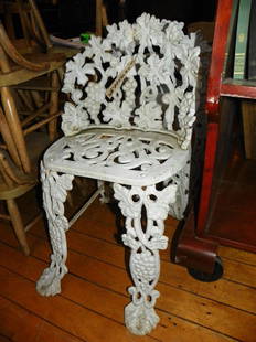 WHITE PTD CAST IRON CHAIR GRAPE MOTIF 4346B: One of two white painted antique cast iron chair in grape with vine motif. One of two being sold separately. 27"H x 18"W x 20"D. Age: C.1930. Material: Cast Iron