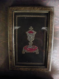 NEEDLEPOINT OF THE CUP OF CHRIST 4046G: Elaborately executed framed needlepoint of "The Cup of Christ" in silver shiney stones. 12"H x 8"W. C. 1880. Material: Needlepoint