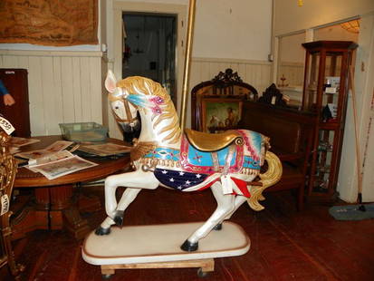 FULL SIZE CAROUSEL HORSE W/INDIAN ACCENT 4328: Contemporary colorful full sized carousel horse with flags on the side and Indian chief head above tail. 66"H x 58"L x 18"D. Contemporary. Material: Fiberglass