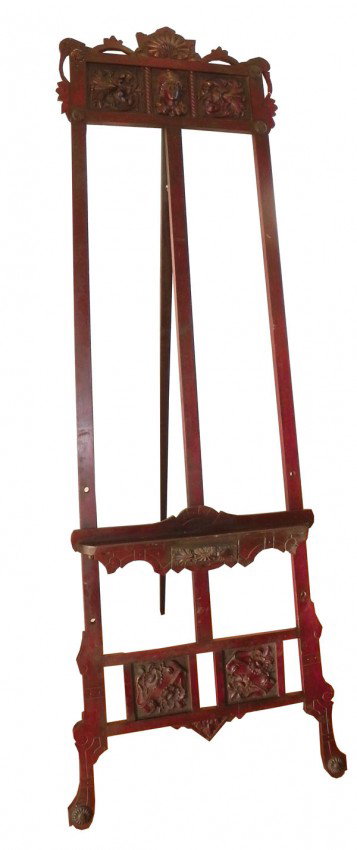 VICTORIAN EASEL W/ FLORAL ACCENTS 4321: Splendid carved and incised Victorian carved easel with lady head, seashell, flowers and incised detailing. 75"H x 28"W. C.1880. Material: Mahogany