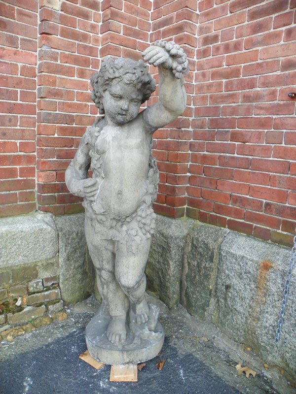 CREDENZA STONE CUPID W/ HOLDING GRAPES 16093: Credenza stone statue of standing cupid holding grapes. Dimensions: 52"H x 20"W x 14"D Age: Contemporary Material: Credenza stone