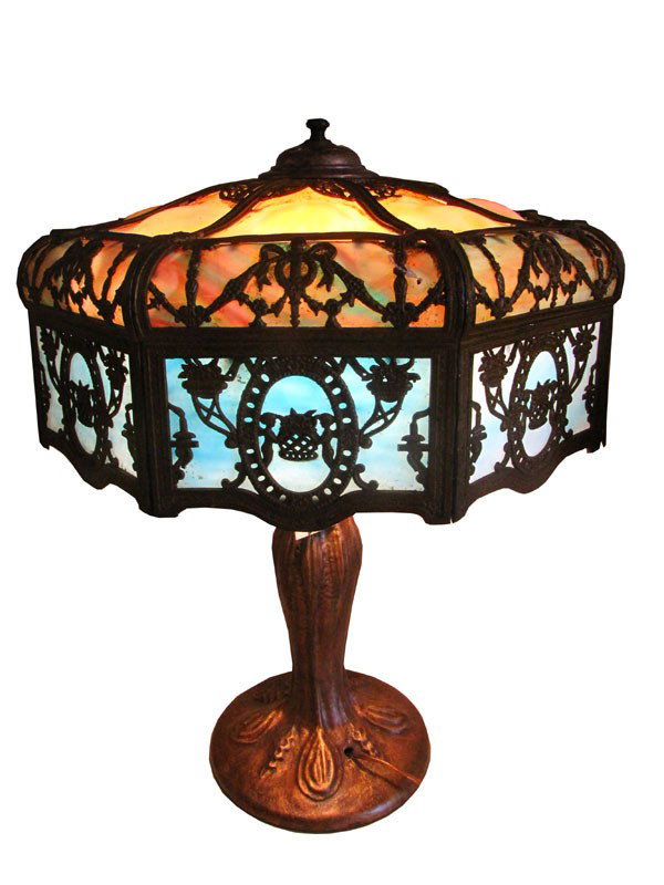 LG TURTLE BACK PANELS SLAG GLASS TABLE LAMP 993982: Lovely tall bent glass table lamp with turtle back bent shade with figural filigree work and three different color glass. Dimensions: 26"H x 19"D Age: 1920 Material: Glass & Spelter