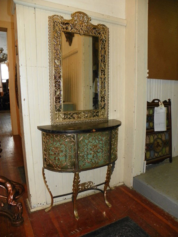 ATTRIB OSCAR BOCH BRASS & IRON VANITY 994063: Polished cast bronze and iron marble top vanity /console table with mirror attributed to Oscar Boch with grape vine and drama mask motif. 67"H x 30"W x 11.5"D. Age: C.1930. Material: cast bronze, iron