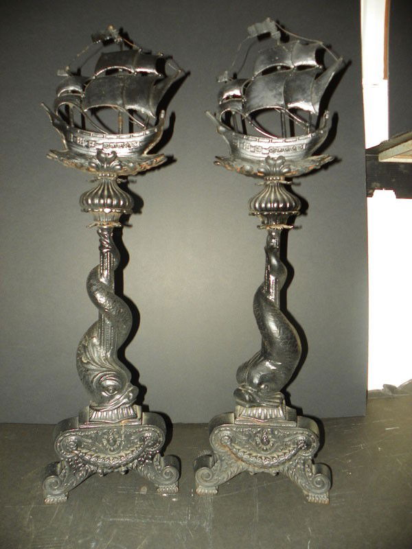 LG BRONZE & IRON ANDIRONS W/SHIPS & DOLPHINS 4611: Oversized uniquely designed cast bronze & iron andirons with twisted tail dolphins and large ship top (sails & flags are cast bronze). Dimensions: 36"H x 10.5"W x 8"D Age: C.1880 Material: Iron & cast