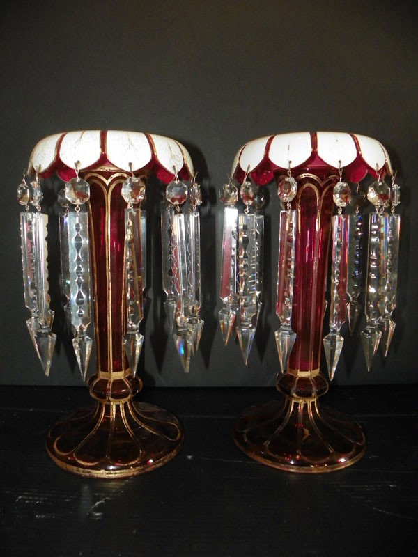 PAIR RUBY LUSTERS W/ CUT CRYSTAL PRISMS 99022: Elaborate pair of ruby lusters with gold and white accents and large cut crystal prisms. Dimensions: 13"H x 7" Dia Age: C. 1880 Material: Crystal
