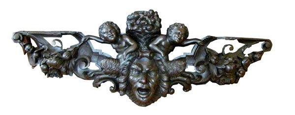 CVD WALNUT ARCHITECTURAL PC W/FACE, CUPIDS 993917: Elaborate carved architectural piece with back to back Pan figures holding deep relief nut and berry garland surrounded by French Rococo style scroll work, center North wind face and fruit filled bask