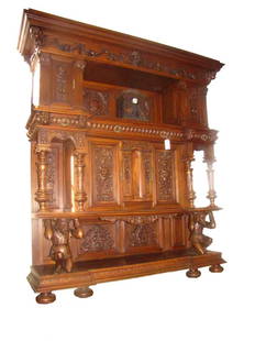 COLOSSAL CARVED WALNUT CABINET W/MEN SUPORTS 14431: This is a powerful piece of work. This colossal carved walnut cabinet captivates you immediately with the endless carvings including men supports, winged cherub cornices, winged griffins, shields,