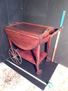 Nice vintage drop leaf tea cart with wood wheels and glass tray: Nice vintage drop leaf tea cart with wood wheels and glass tray.This is a great looking little tea cart having wood spoke wheels and solid wood small wheels both of which are wrapped with rubber. I am