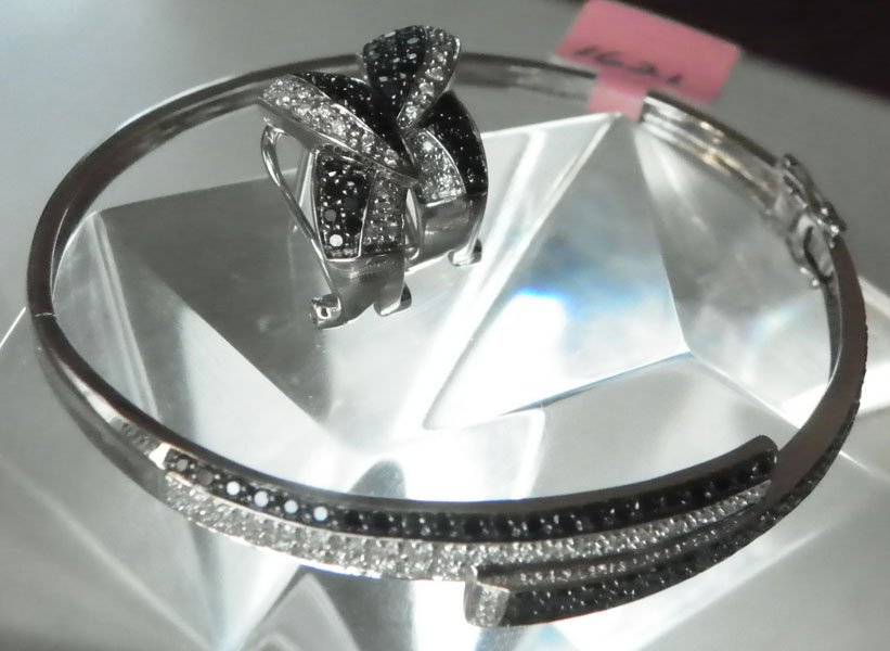 14K WHITE GOLD BLACK &WHITE DIAMOND EARINGS 1621: 14K white gold, black and clear diamond earrings and bangle bracelet set with 2.4ct diamonds. 11.3 gram bangle bracelet and 5.4g earrings. Material: 14K white gold, black and white diamonds.