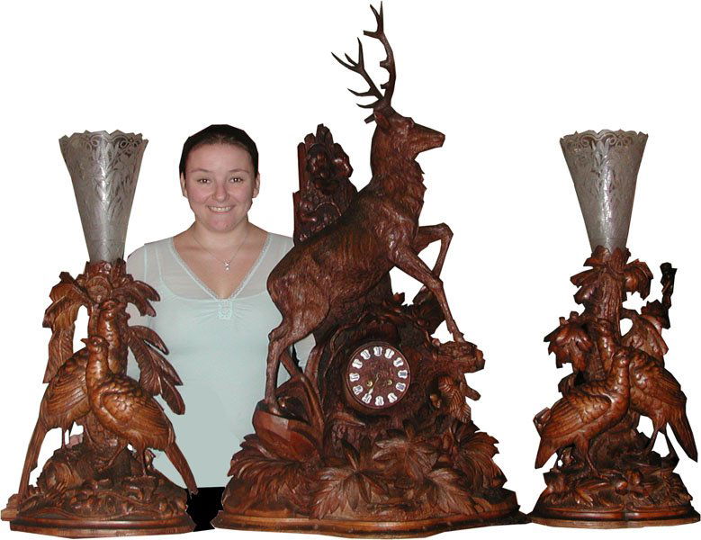 3 PC BF CLOCK SET W/BUCK,TREE,& FOLIATE CRVING16079: Out of this world highly detailed 3 pc Black Forest clock set with stellar buck standing over tree trunk formed clock with fern & foliate carvings and side cut & etched epergnes with pheasants. Dimens