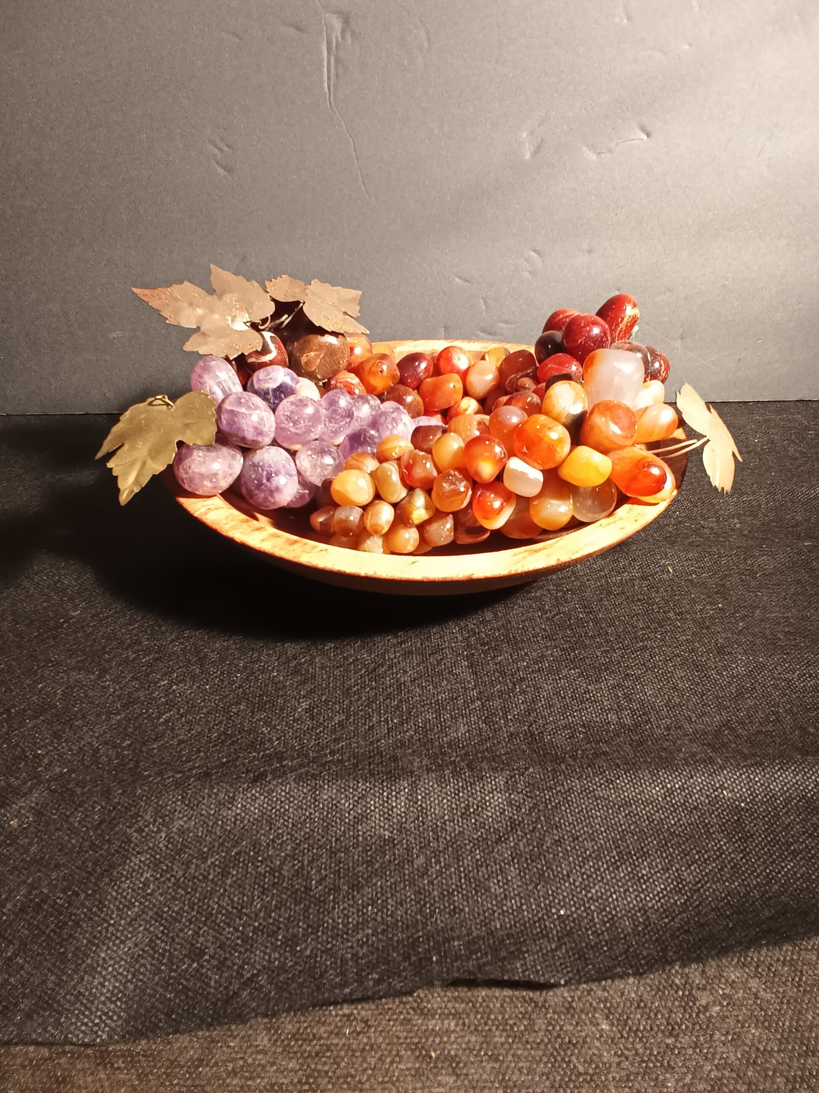 Vintage Onyx & Glass grapes with stamped brass & steel leaves in old wood bowl: Vintage Onyx & Glass grapes with stamped brass And steel leaves in old wood bowl. The closer I look at these grapes I'm almost thinking that they are all onyx. The purple ones are the ones that I was 