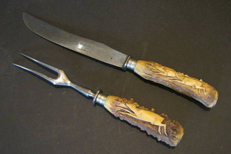 2PC J.A. HENCKLES CUTLERY SET W/SCRIMSHAW HANDLES 1526: Unique 2pc J.A. Henckles carving set with carved scrimshaw deer handles. The knife is 14 1/2"Long and the blade is 8 3/4"Long. The fork is 11" Long.