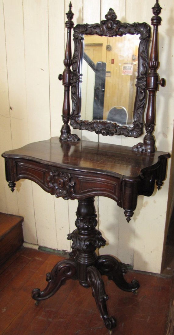ROSEWOOD CHILDS VANITY W/ACANTHUS LEAVES & PAW FEET5494: Incredibly detailed carved Rosewood vanity with swivel top mirror featuring crest top, carved shell and leafs all around. The mirror is held on by carved columns with paw feet bottoms. Lovely carved d