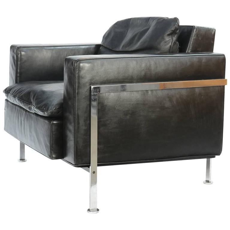 Swiss RH-302 Club Chair: A wonderful club chair from Swiss design team Trix and Robert Haussmann in its original, distressed black leather on a chromed steel frame. Arm height is 18 inches. Inside seat dimensions are 25 inche