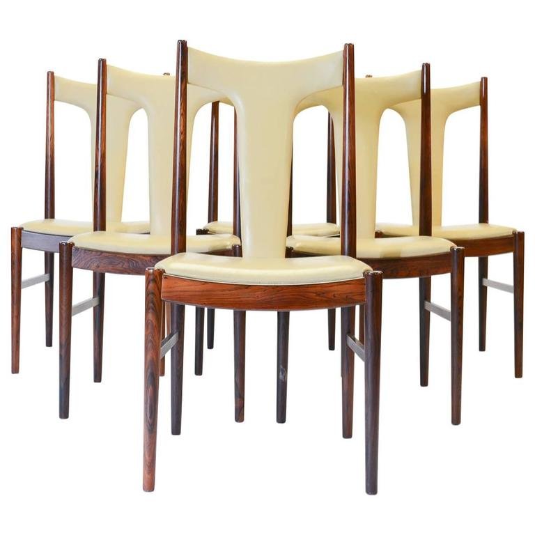 6 Arne Vodder Rosewood Dining Chairs: Six rare and magnificent high back dining chairs in rosewood and butter leather by Arne Vodder for Sibast of Denmark. Vodder's classic style mimicking natural forms is present here in the simple, yet