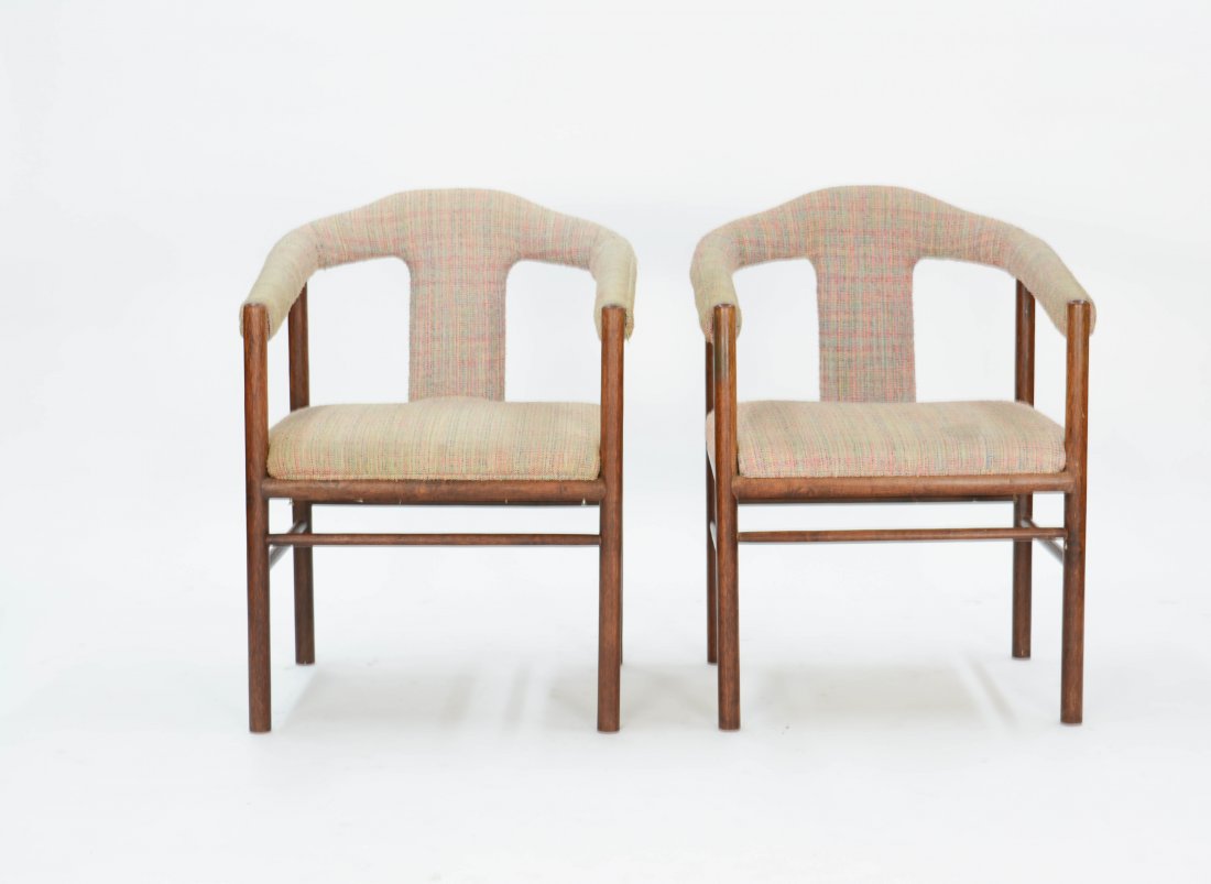 A Pair of Rosewood Arm Chairs After Arne Vodder: Two simple Brazilian rosewood chairs with elegantly curved arms in the with the refinement of Vodder's designs. 31 in. H x 23 in. W x 22 in. D Seat Height 17 in. Arm Height 25 in.