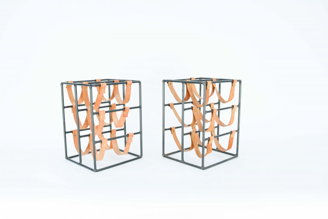 A Pair of Arthur Umanoff Iron and Leather Wine Rack: A pair of iron and leather wine racks by Arthur Umanoff. 14 in. h x 9.5 in. L x 10 in d.