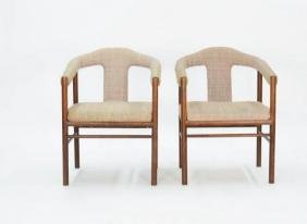 A Pair of Rosewood Arm Chairs After Arne Vodder: Two simple Brazilian rosewood chairs with elegantly curved arms in the with the refinement of Vodder's designs. 31 in. H x 23 in. W x 22 in. D Seat Height 17 in. Arm Height 25 in.