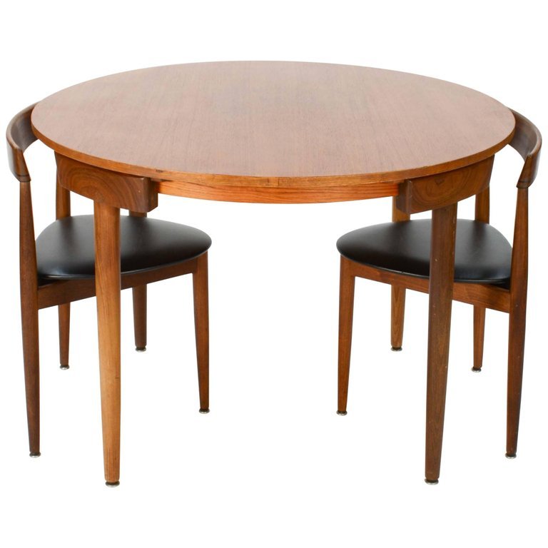 Hans Olsen Dinette Nesting Set for Frem Rojle: A Hans Olsen Dinette nesting set for Frem Rojle that has two chairs and a fixed top. The chairs measure: 28.5\" H, seat H 17\" 19.5\" W 16.5\" D.29.75 in.H x42 in.Dia