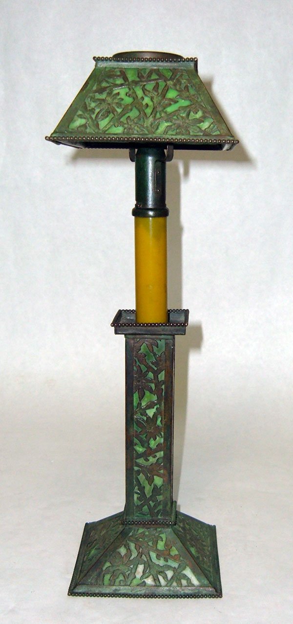 Apollo Studios Candle Lamp w/Green Slag Glass: Apollo Studios candle lamp with green slag glass and bronze cut-out floral panels. Note 2 glass panes in shade with cracks. 15 3/4"h. Shade 5"w. $200-300