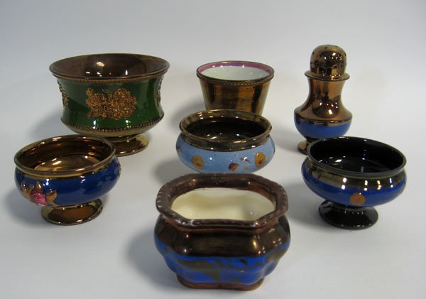 Seven pieces of Copper Lustre including master sal: Seven pieces of Copper Lustre including master salt cellars, pepper pat, bowl with green band, with Copper Lustre embossing. Some minor damages.