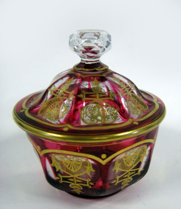 Victorian cranberry cut-to-clear covered jar with: Victorian cranberry cut-to-clear covered jar with gild decoration. Condition is very good with some minor wear to gilding on the covered rim of jar. 5 3/4''h.x5 1/2''dia.