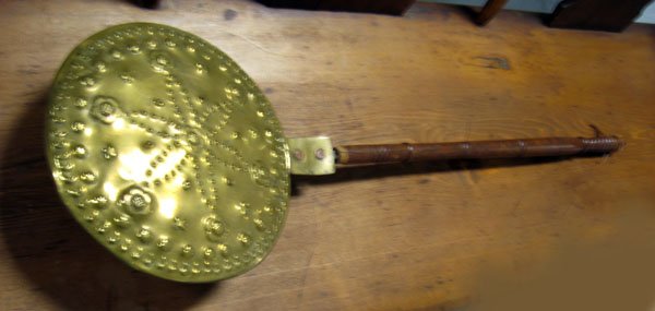 Brass bed warmer with pierced and punched daisy de: Brass bed warmer with pierced and punched daisy design. Note brass end to wooden handle is missing. Appropriate age wear. $80-120