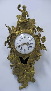 Gilt bronze clock. 19th century French gilt bronze: Gilt bronze clock. 19th century French gilt bronze figural Cartel clock with cherubs and maiden. Time and strike, porcelain face. Maker unknown, numbered 4805 - 72. Missing pendulum & key Appropriate