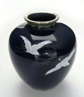 Cloisonne vase. An Indaba Japanese cloisonne vase: Cloisonne vase. An Indaba Japanese cloisonne vase decorated with cranes against a dark blue back ground. Ca 1900. Appropriate age wear. 4''h. $250-350