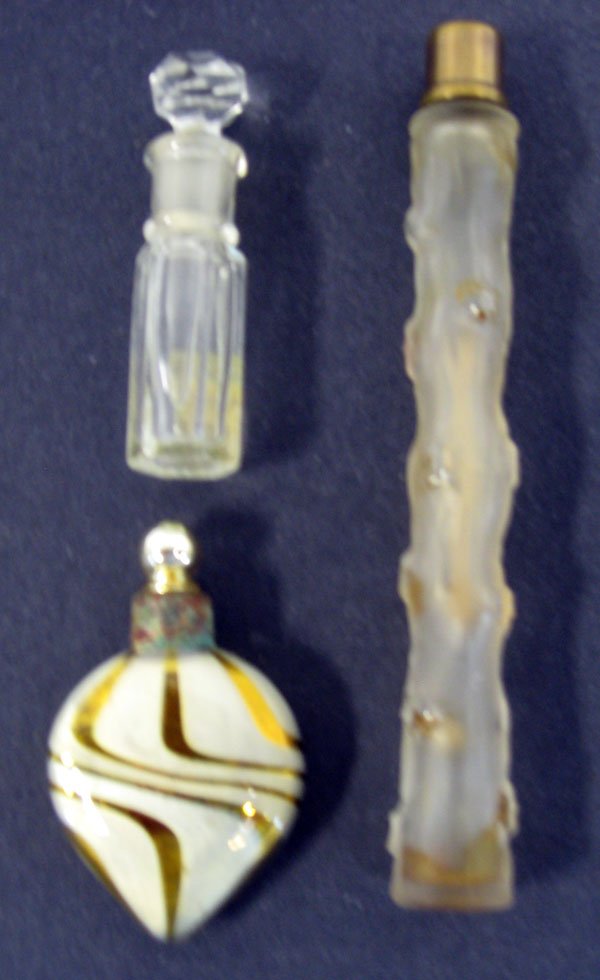 Three perfume flasks. Three lay down perfume flask: Three perfume flasks. Three lay down perfume flasks of various shapes and sizes. Appropriate age wear. $50-80