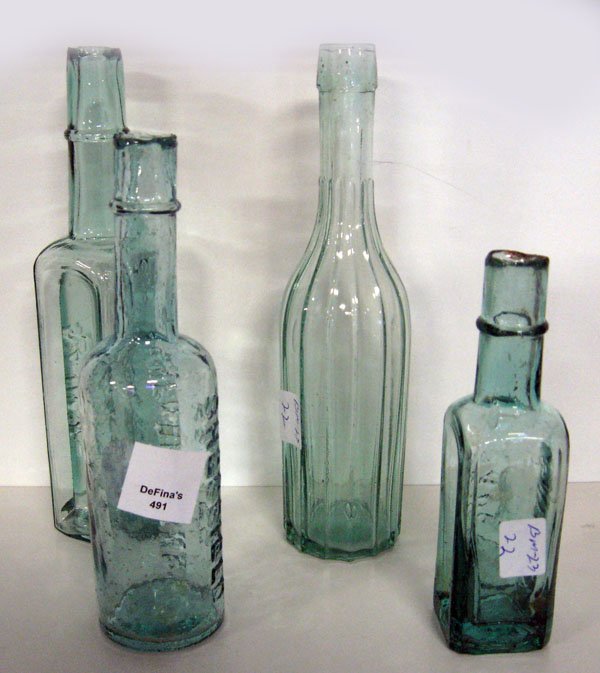 Bottles, four relish and sauce bottles, 1840-1850': Bottles, four relish and sauce bottles, 1840-1850's. Three are shear tops. Appropriate age wear. $30-60