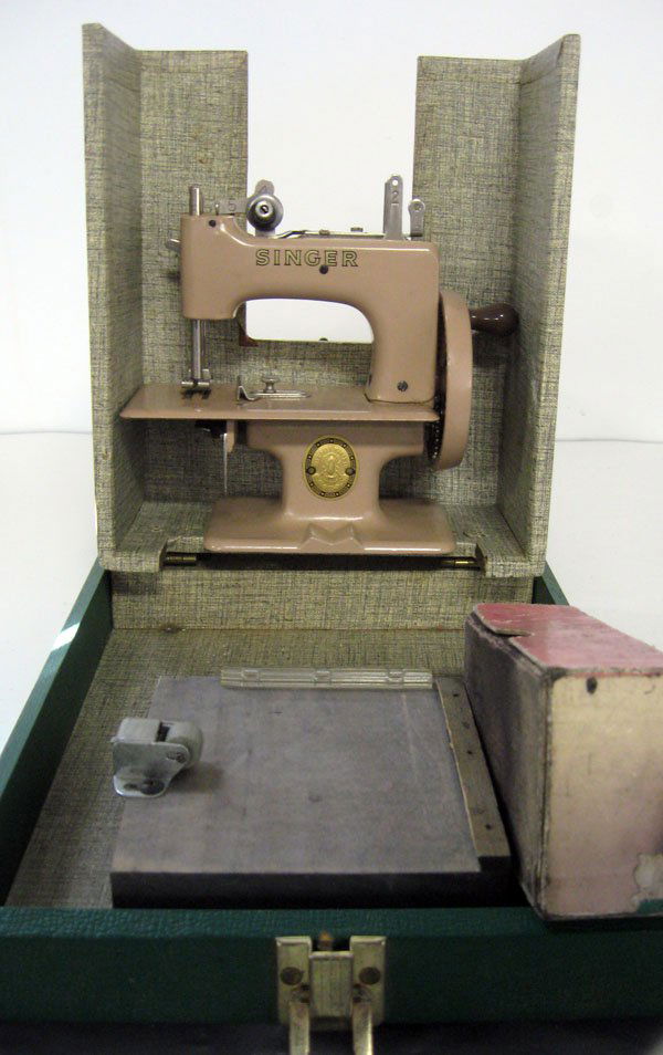 Singer ''Sew Handy'' sewing machine in original case. A: Singer ''Sew Handy'' sewing machine in original case. Appropriate age wear.