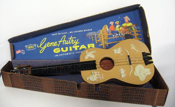 Gene Autry Emenee guitar in case, 1950's. Excellent ove: Gene Autry Emenee guitar in case, 1950's. Excellent overall, in original case. Appropriate age wear. 4''h x 32 1/2''l x 12 3/4''d. $80-130