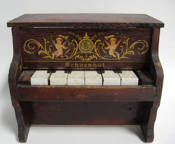 Schoenhut 1920's toy piano. Good condition with wear an: Schoenhut 1920's toy piano. Good condition with wear and repainted keys. Appropriate age wear. 6 3/4''h x 7 1/2''w x 5 3/4''d. $40-60