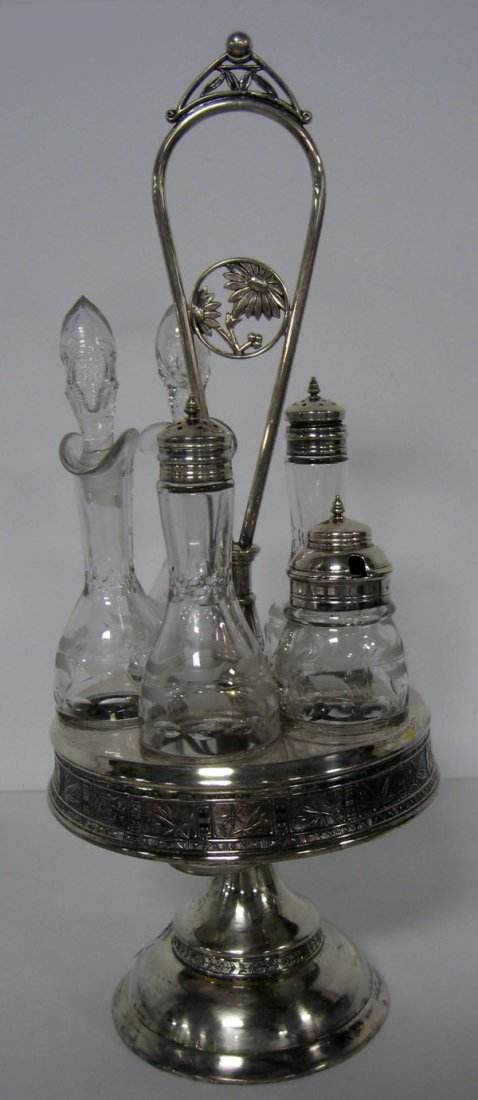 Victorian caster set with silverplate holder. Note dama: Victorian caster set with silverplate holder. Note damage to one stopper. Appropriate age wear. $60-100